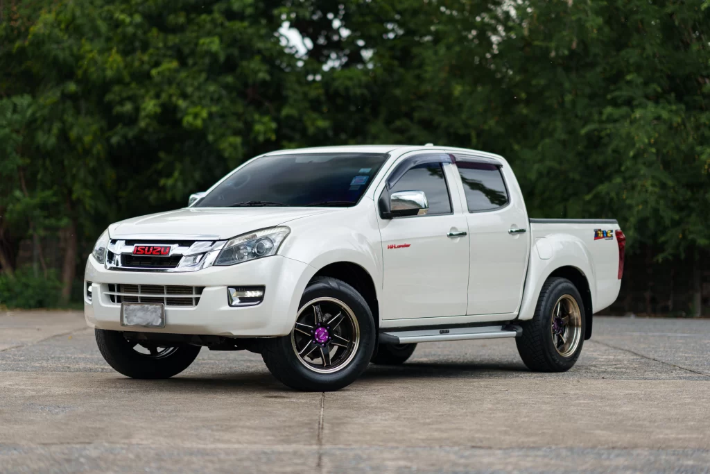 White Isuzu pickup truck parked outdoors, representing Isuzu mechanics at Real Pro Auto.